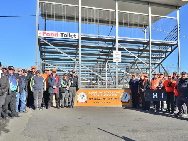 QMROA Members standing next to the QMROA sign at Morgan Park Raceway